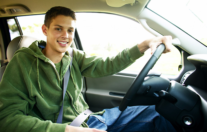 A teen sitting in a driver's seat