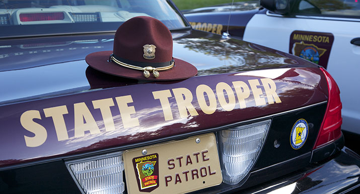 A trooper's hat on the back of a squad car.